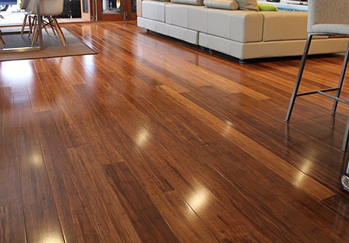 Glossy brown hardwood in a family living room, hardwood floor refinishing in Coventry, RI
