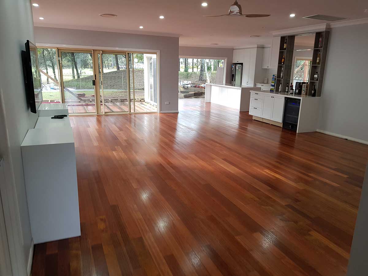 Refinished hardwood with a high-gloss finish across an open living room in Smithfield, RI