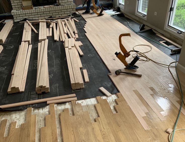 Hardwood floor boards being replaced during a floor repair
