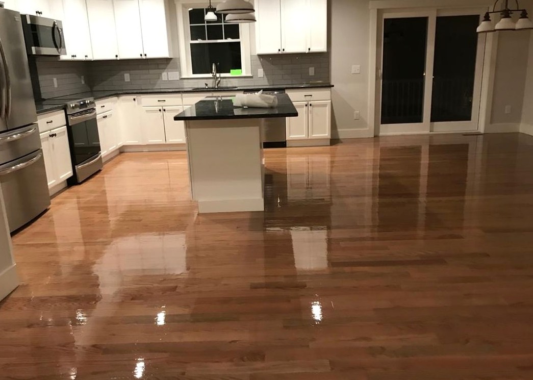 Glossy refinished oak beside white cabinetry in a Johnston home, Brazil Floors