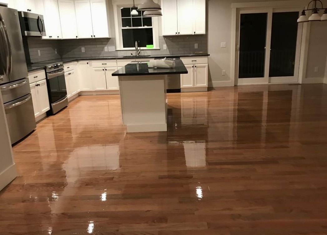 Sanded and glossy kitchen hardwood beside white cabinetry in a North Providence home, Brazil Floors