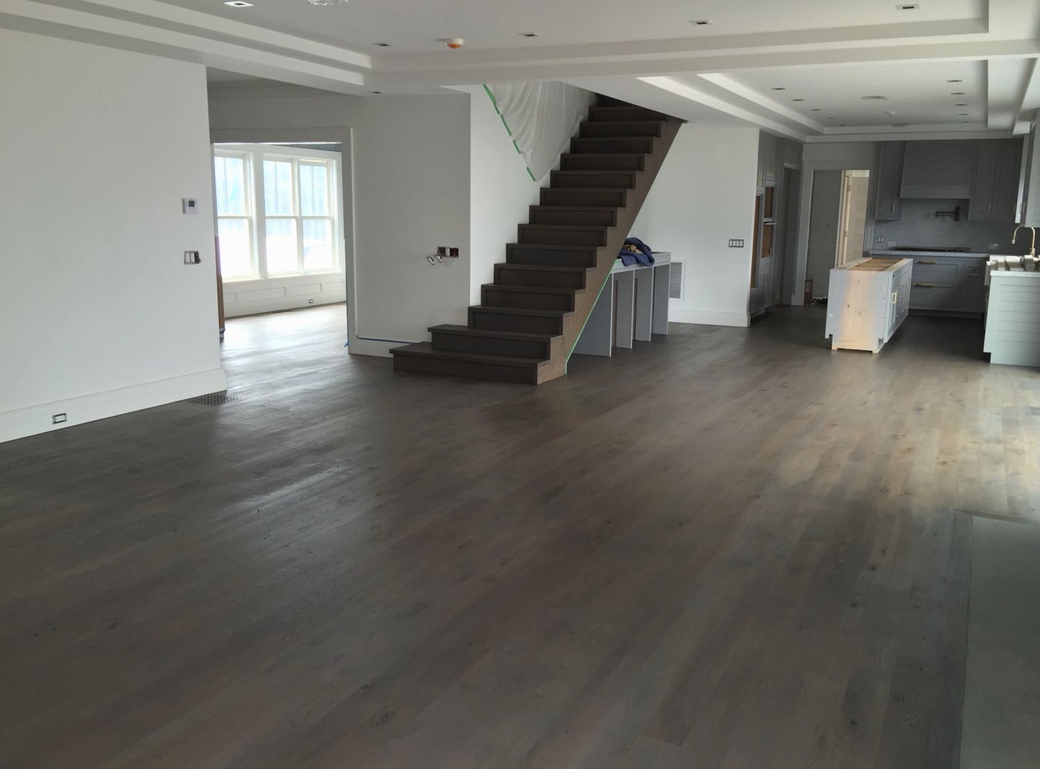 Sanded and restained hardwood in an open layout in a home near Usquepaug, Brazil Floors