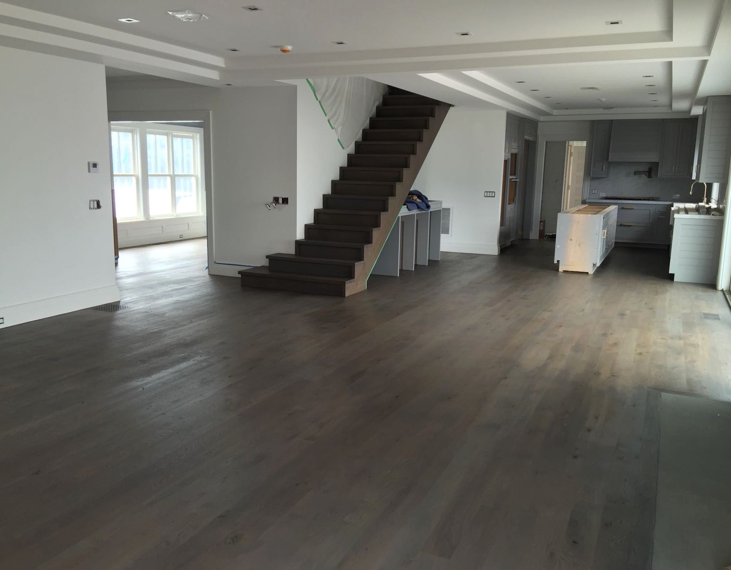 Espresso toned restained hardwood in a wide open space close to Nanaquaket Pond, Brazil Floors