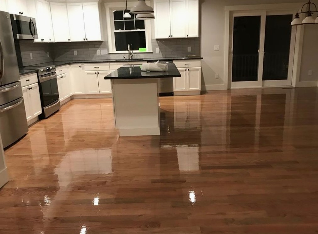 Recoated hardwood beside white cabinetry for a family near Conimicut, Brazil Floors