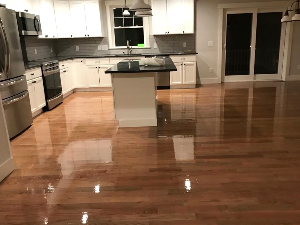 Glossy refinished hardwood around the island in a Woonsocket home, Brazil Floors