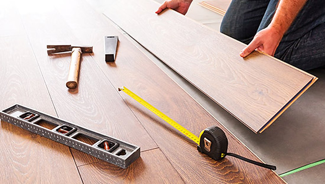 Level and tape measure on new LVP near Paradise Avenue, Brazil Floors
