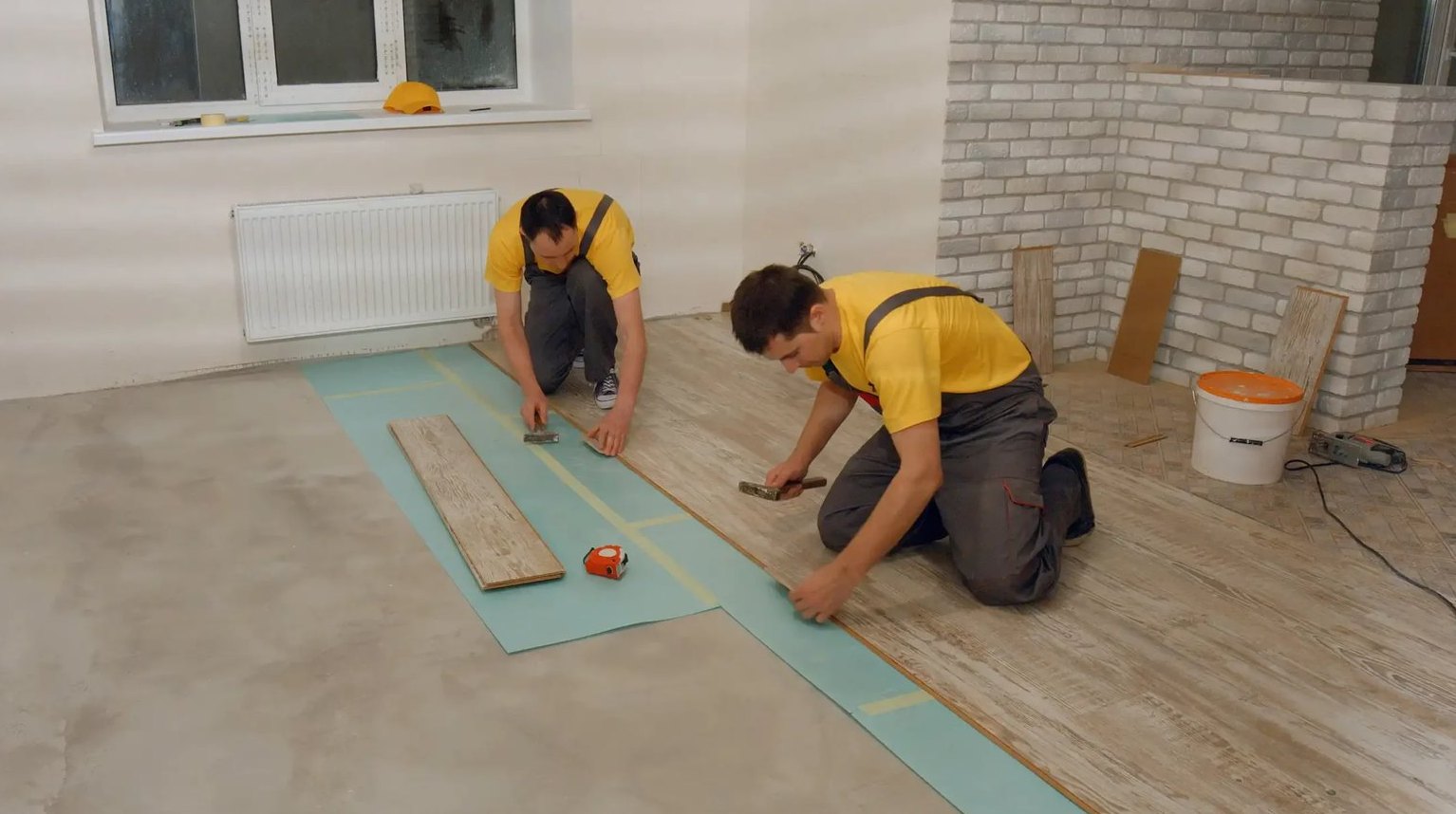 Crew laying plank rows in a Watch Hill cottage, Brazil Floors