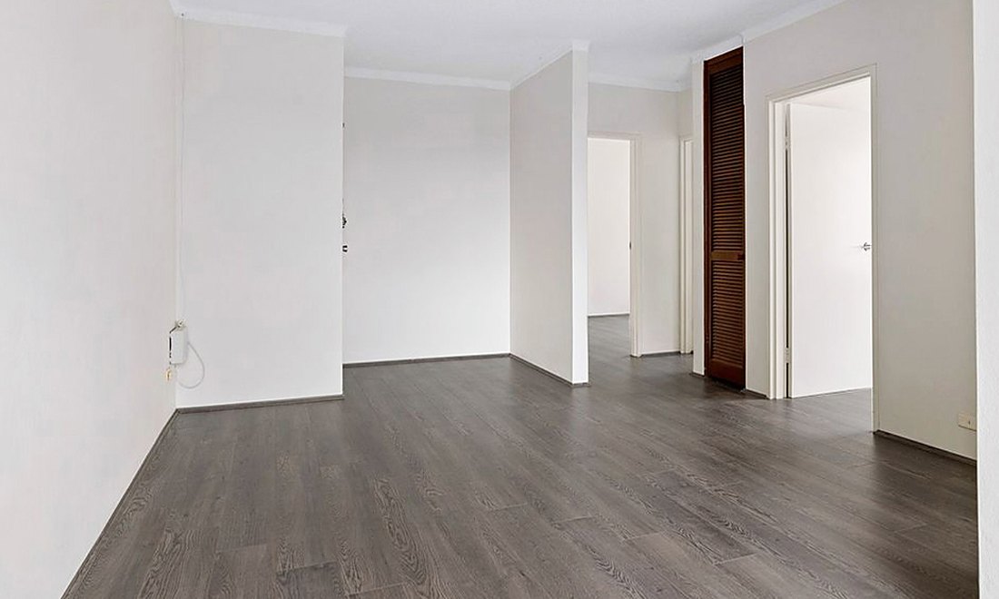 Gray laminate through an empty hallway and rooms in a Knightsville house, Brazil Floors