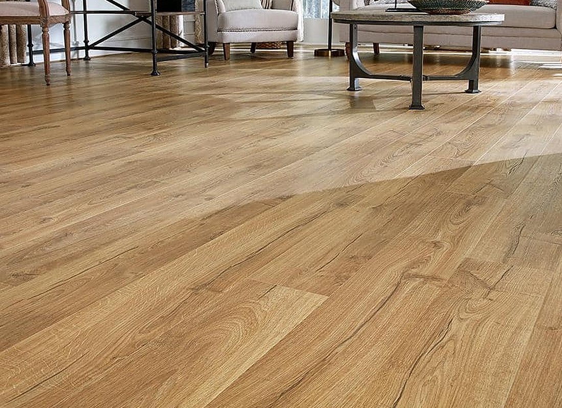 Light oak look laminate across an open living and dining room in Harmony, Brazil Floors