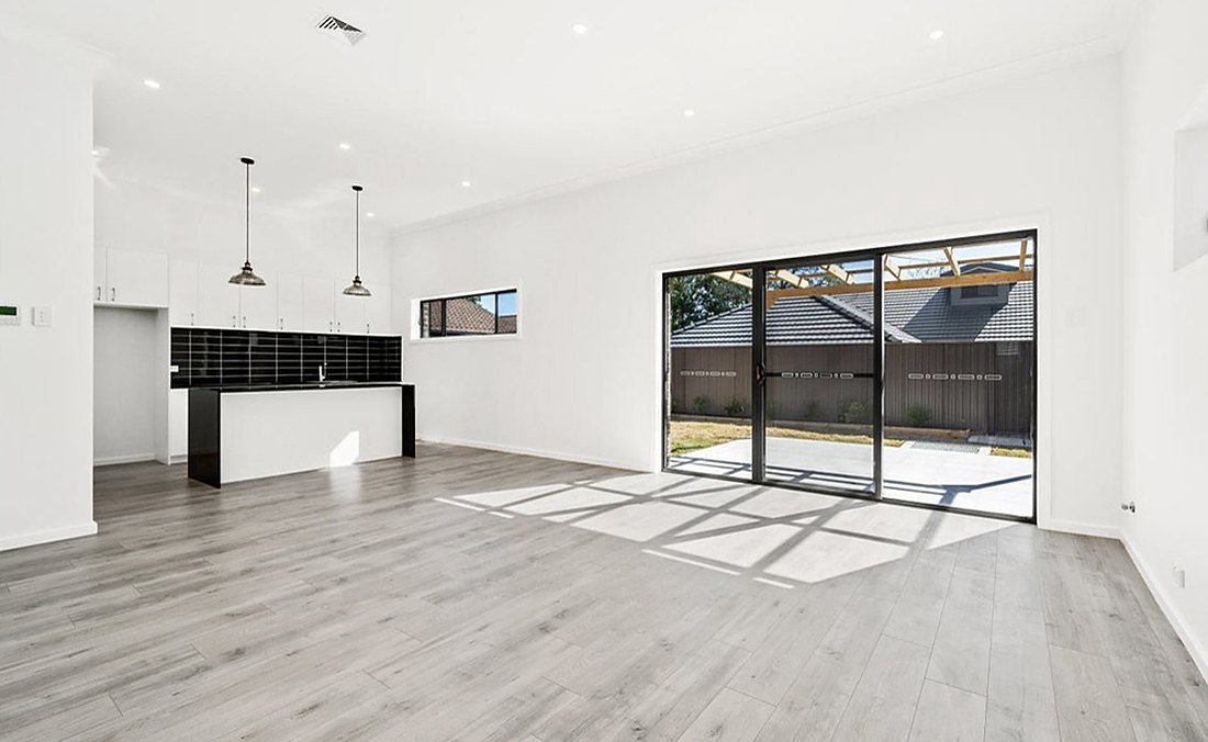 Gray laminate in an empty open kitchen with a slider near Slater Park, Brazil Floors