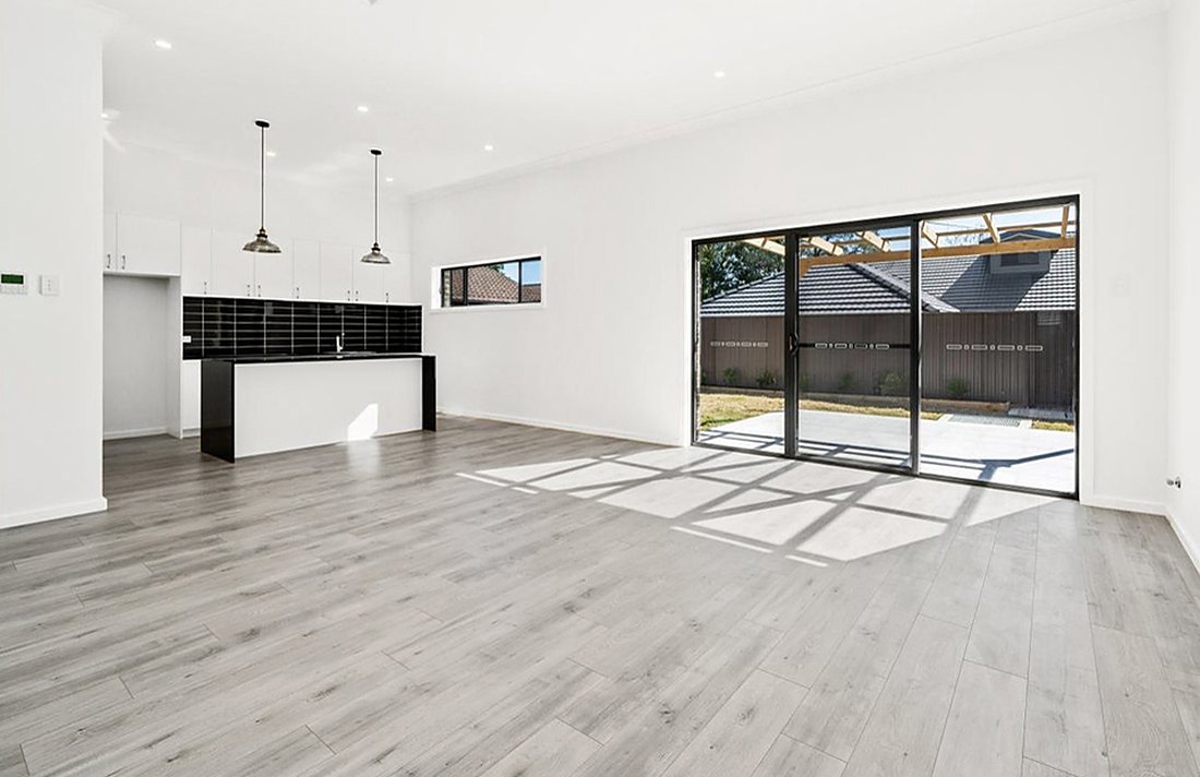 Gray laminate in an empty open kitchen with a slider by Nanaquaket Pond, Brazil Floors