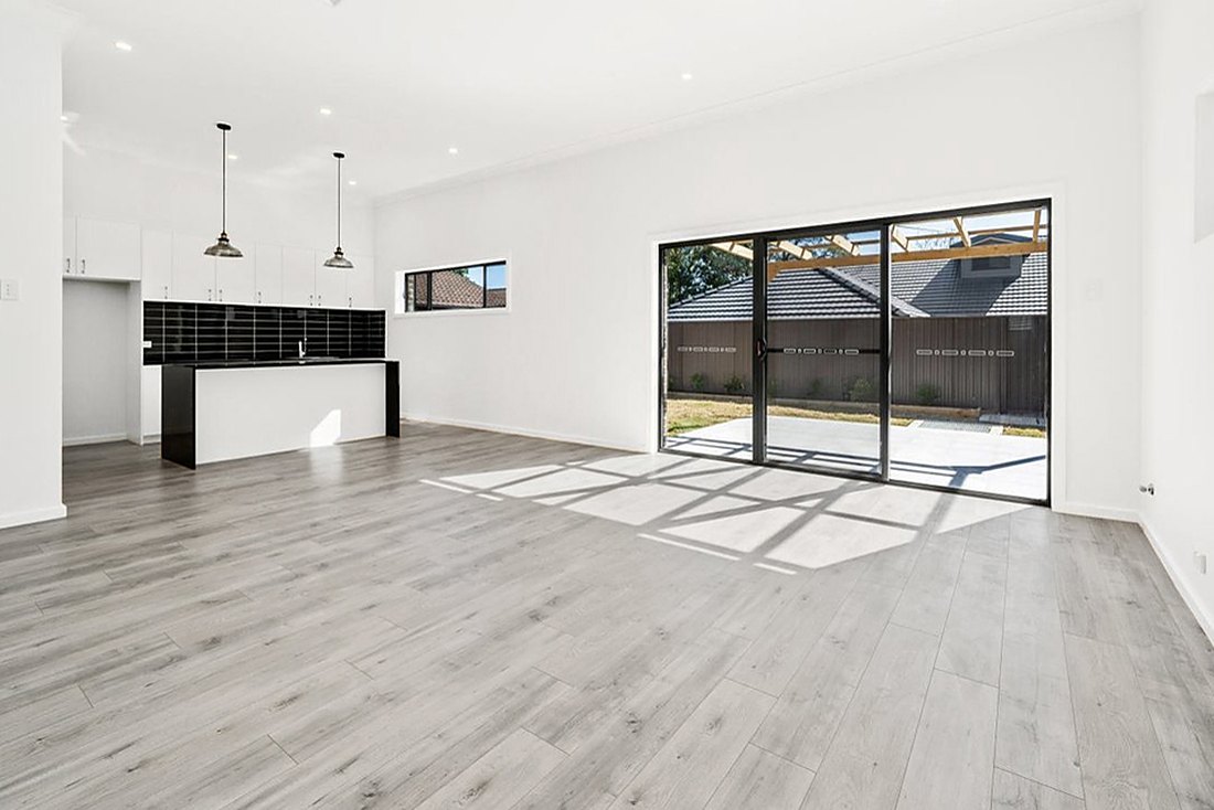 Gray laminate in an empty open kitchen with a slider in a Bernon home, Brazil Floors