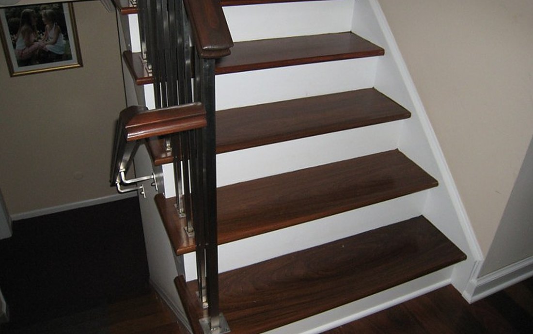 Dark stained treads set over white risers in a Tiverton cape, Brazil Floors