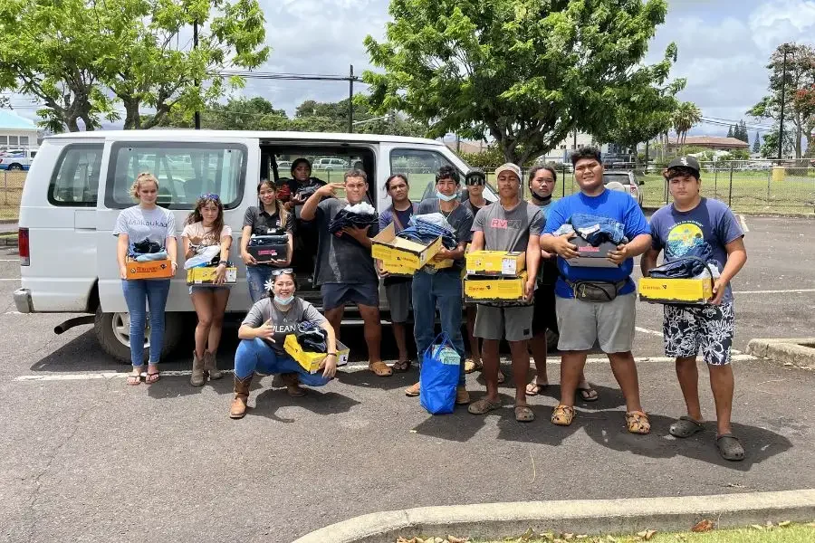 Local residents holding boxes of local produce