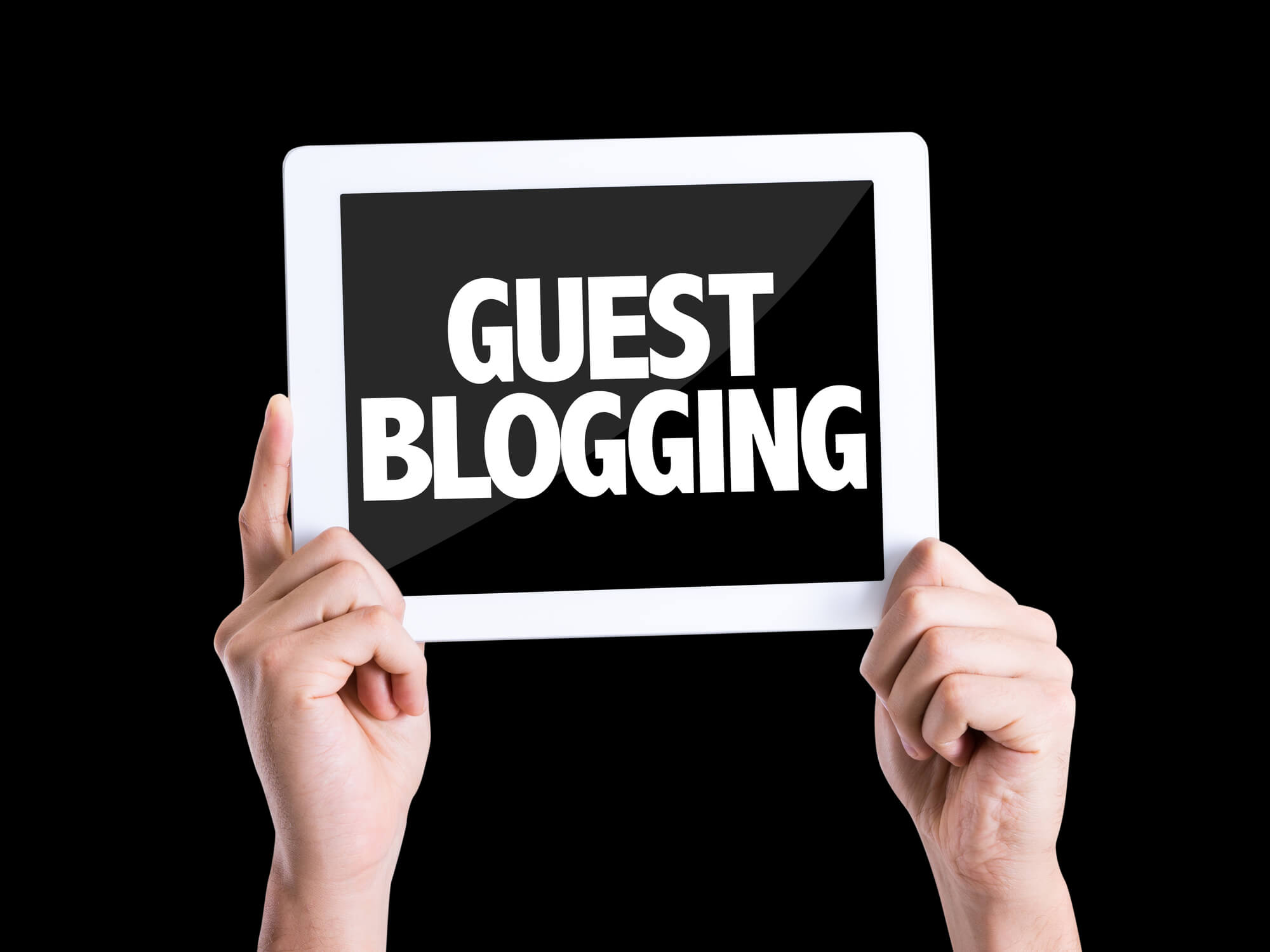 west palm beach seo expert holding tablet that shows guest blogging on screen