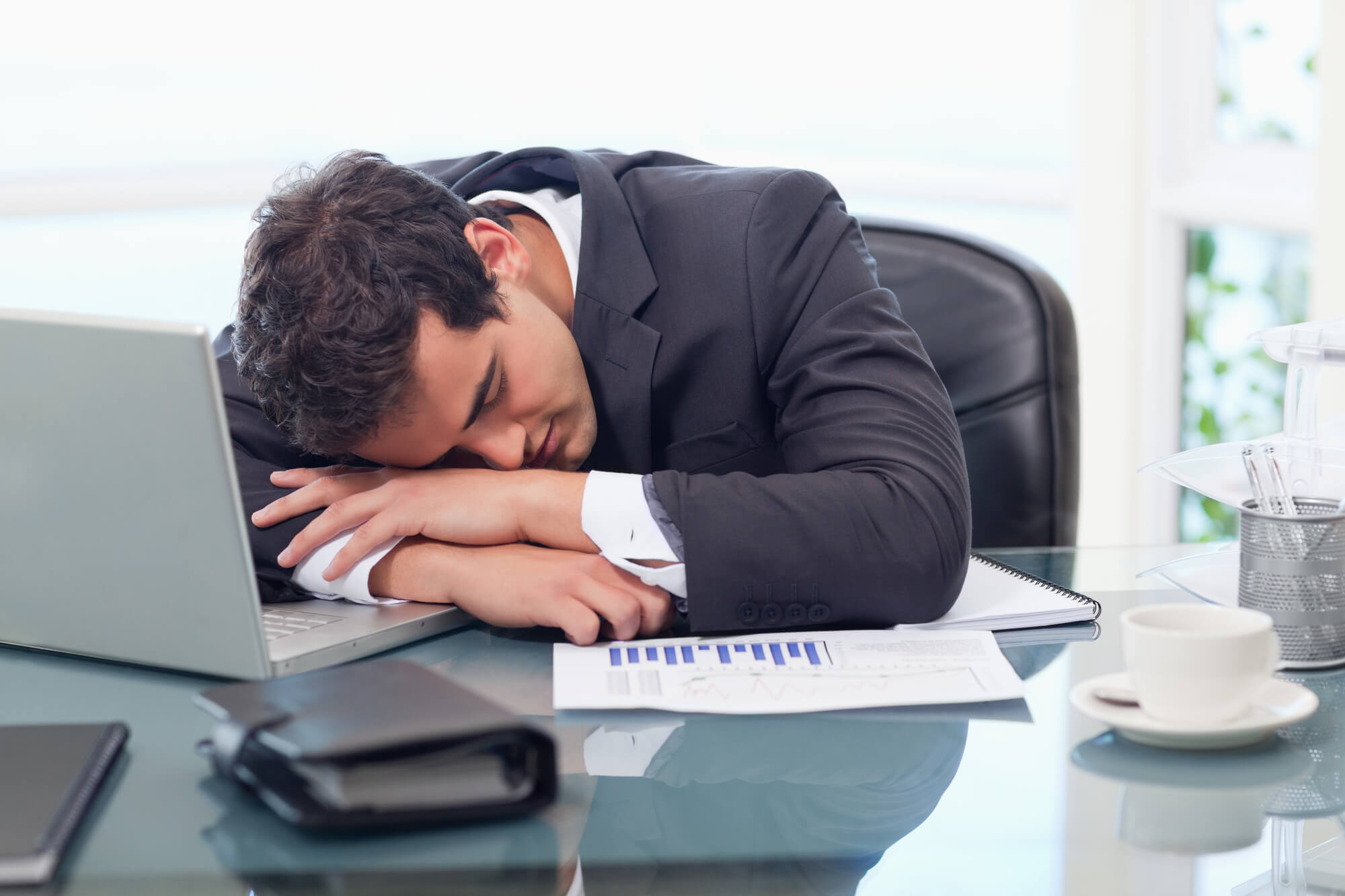 man sleeping on his desk