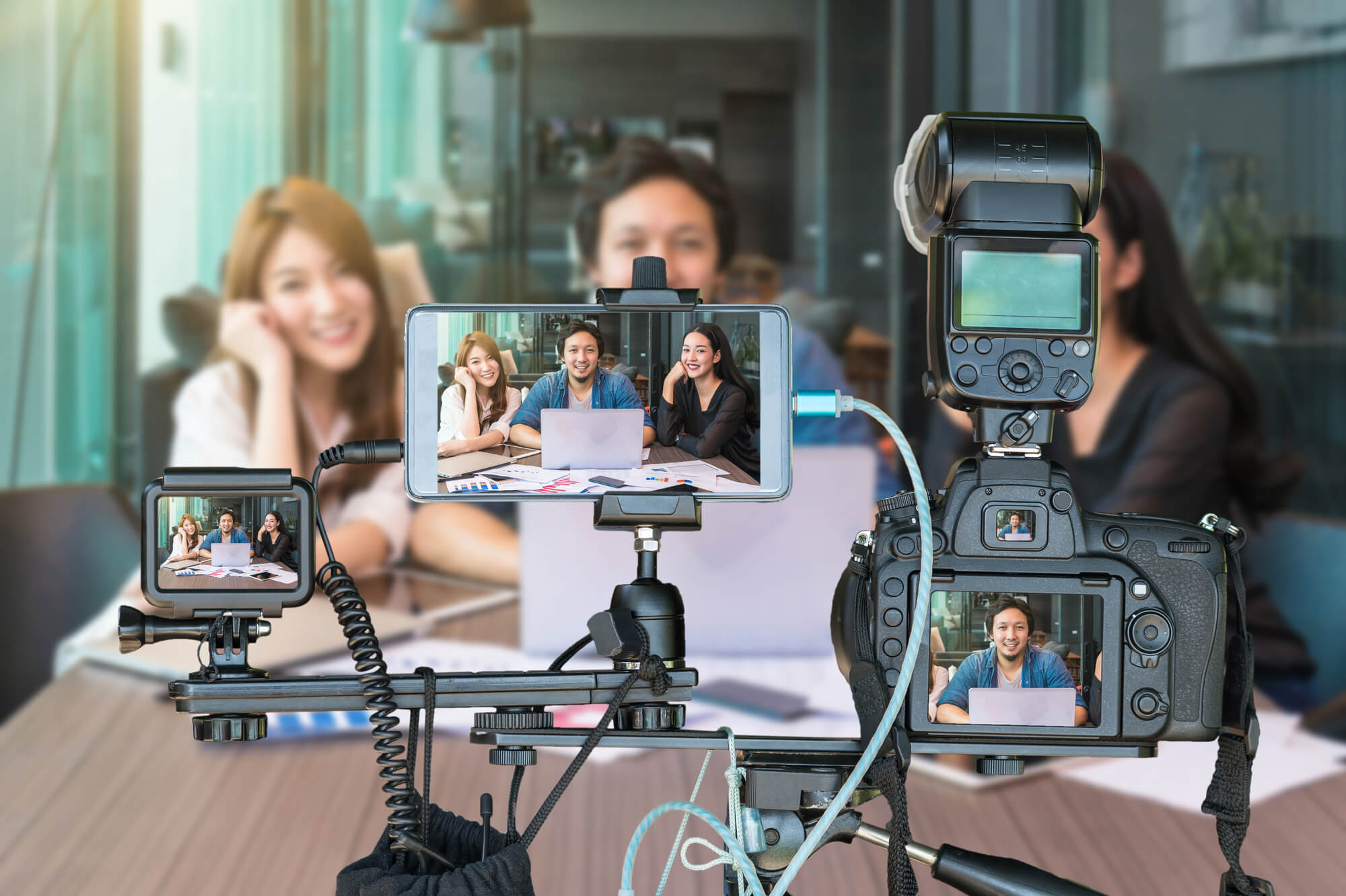 three people using different devices to live stream