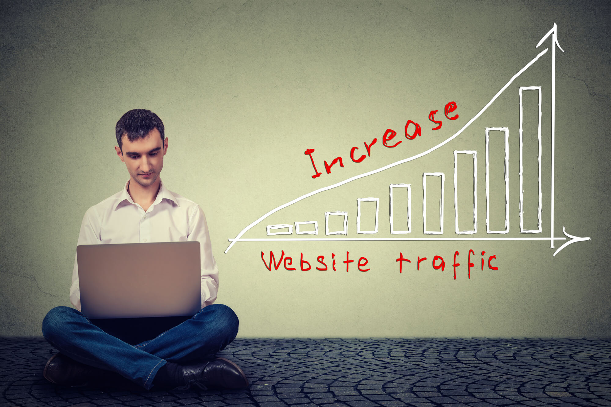 man working on laptop to increase traffic