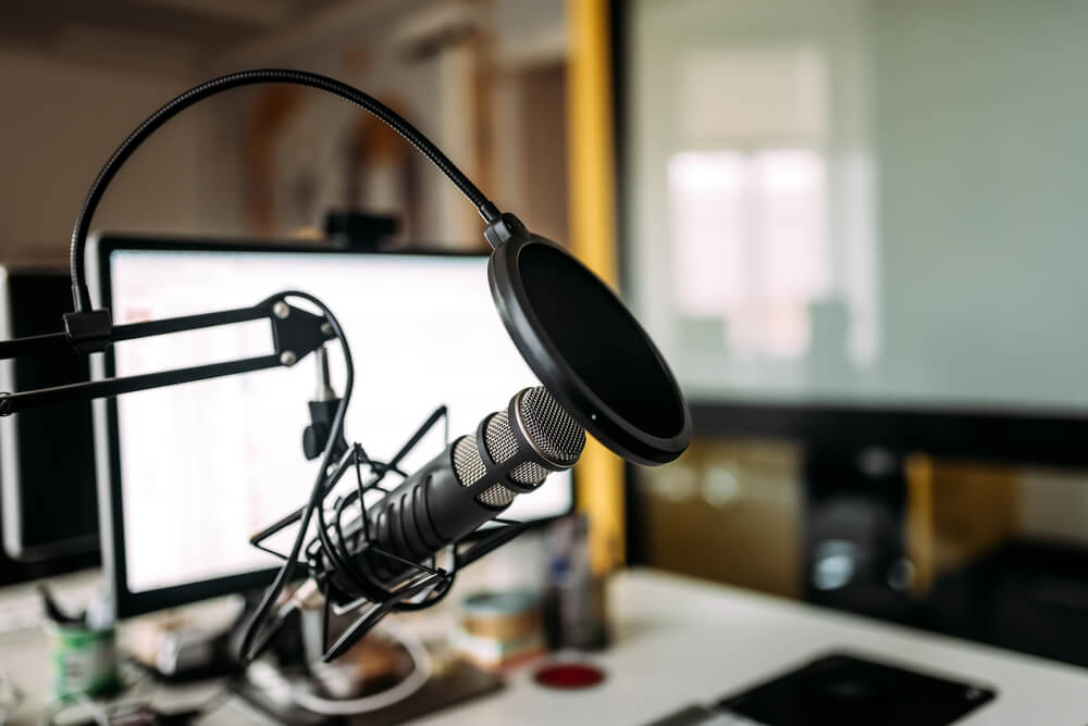 photo of podcasting equipment: microphone and computer