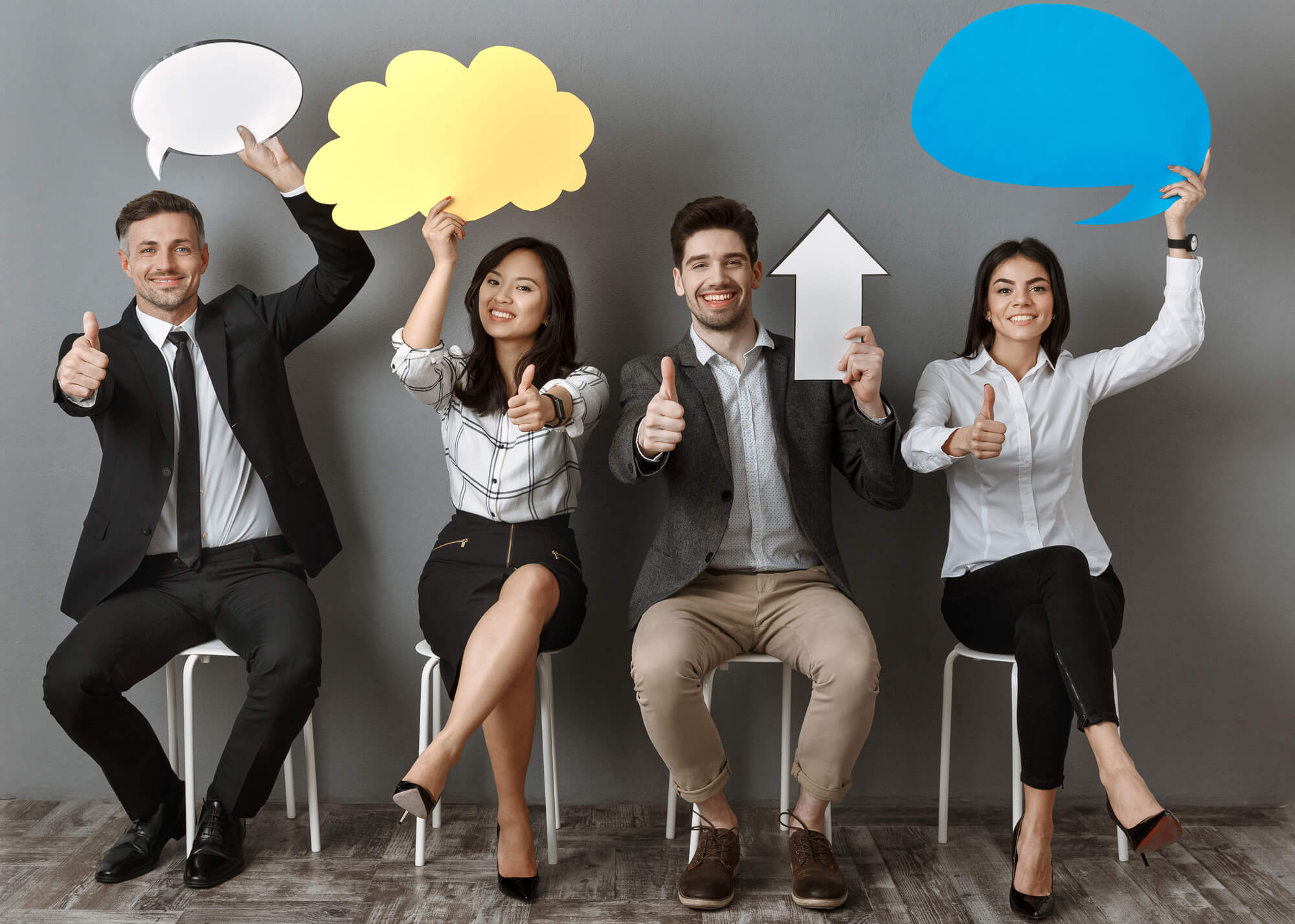 digital marketers holding speech bubbles and arrow pointing up while giving thumbs up