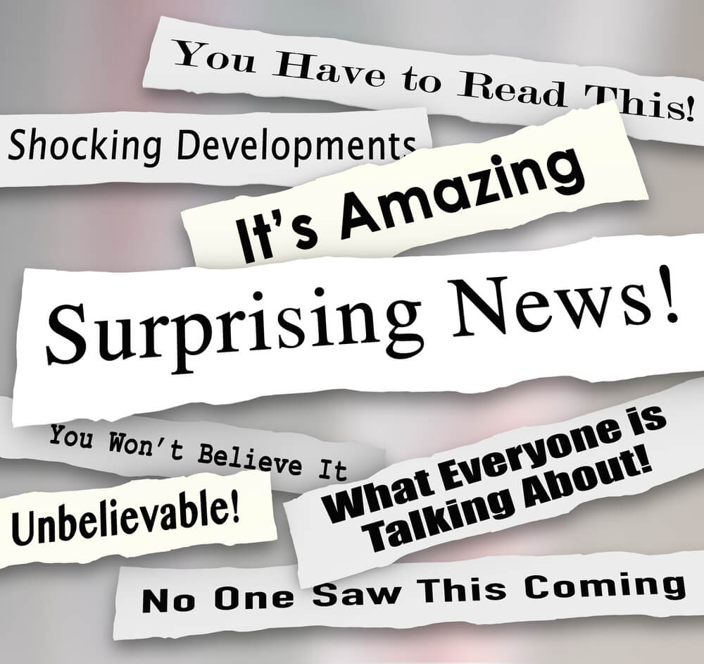 Compelling news headlines torn or ripped from newspapers