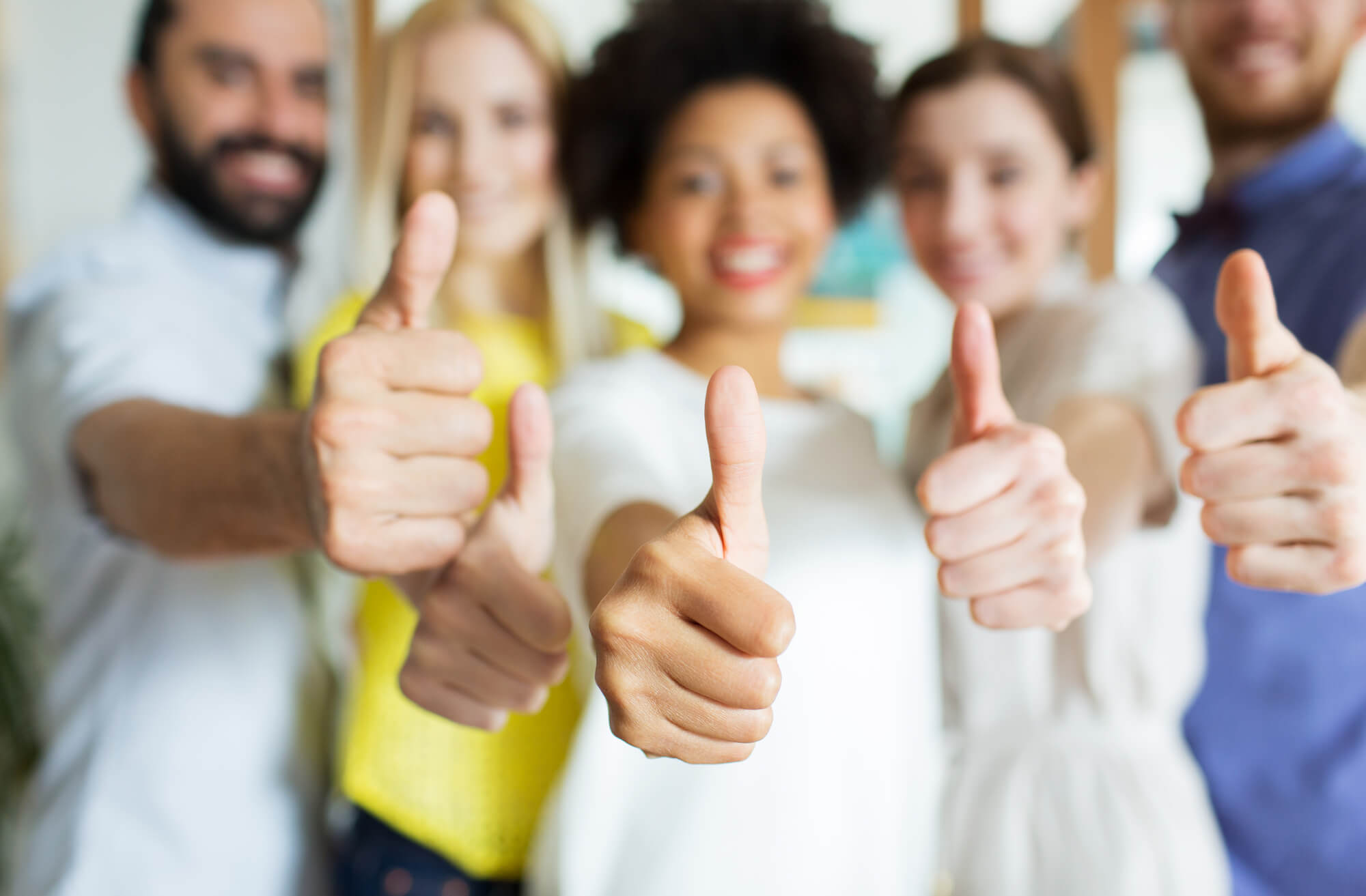 group of people giving thumbs up