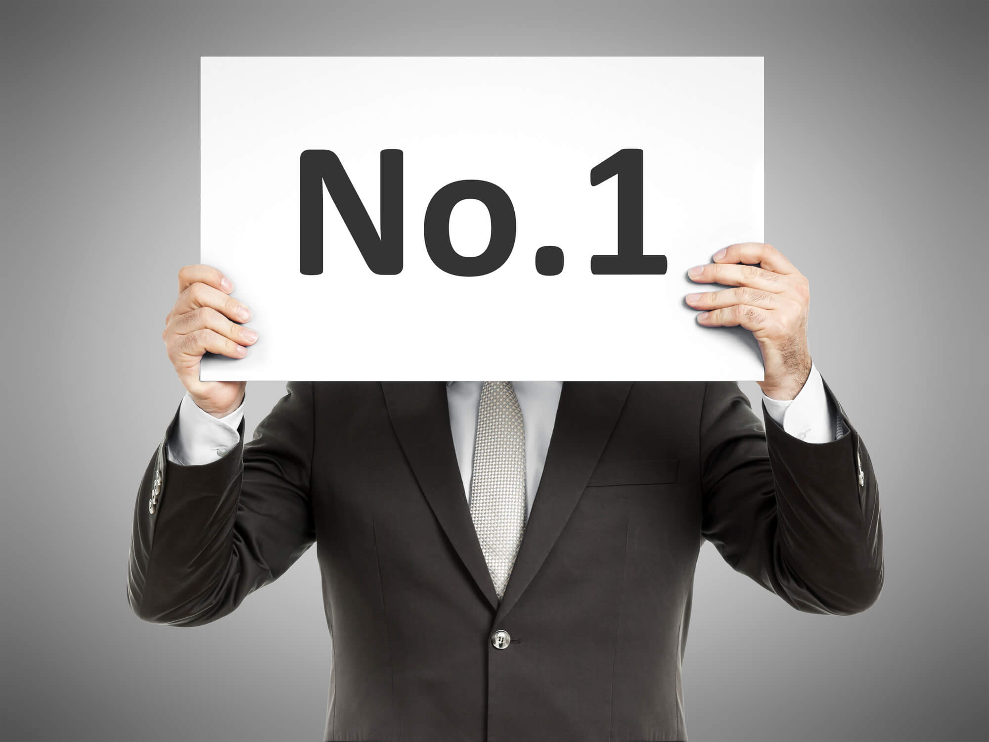 man holding sign saying no. 1
