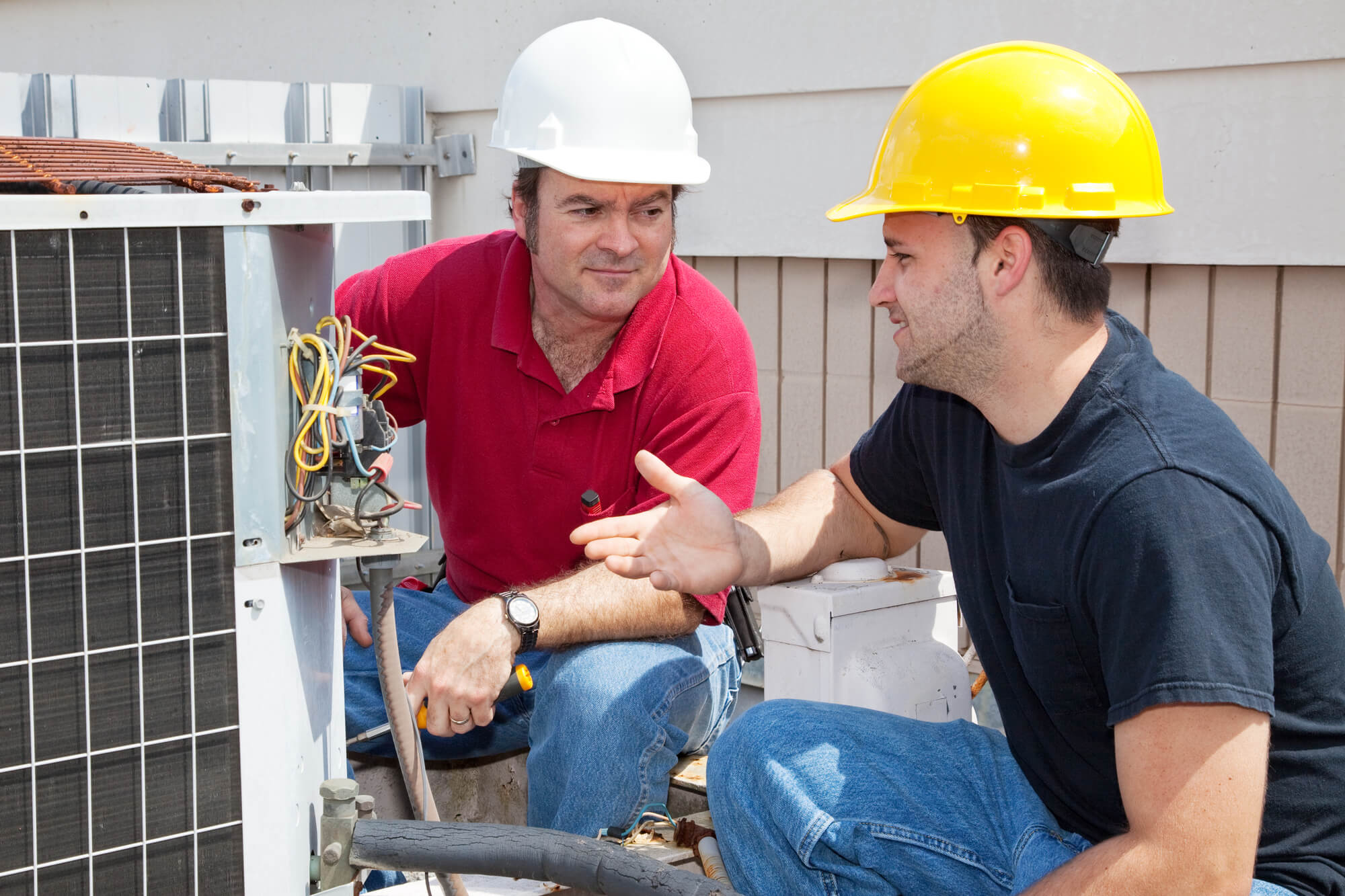 Marketer and HVAC engineer discussing about content to put on their website to boost HVAC SEO.