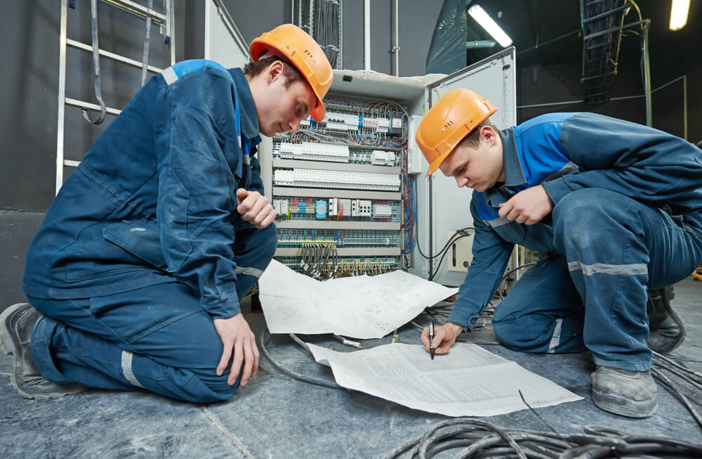 two electricians posing for Instagram. 