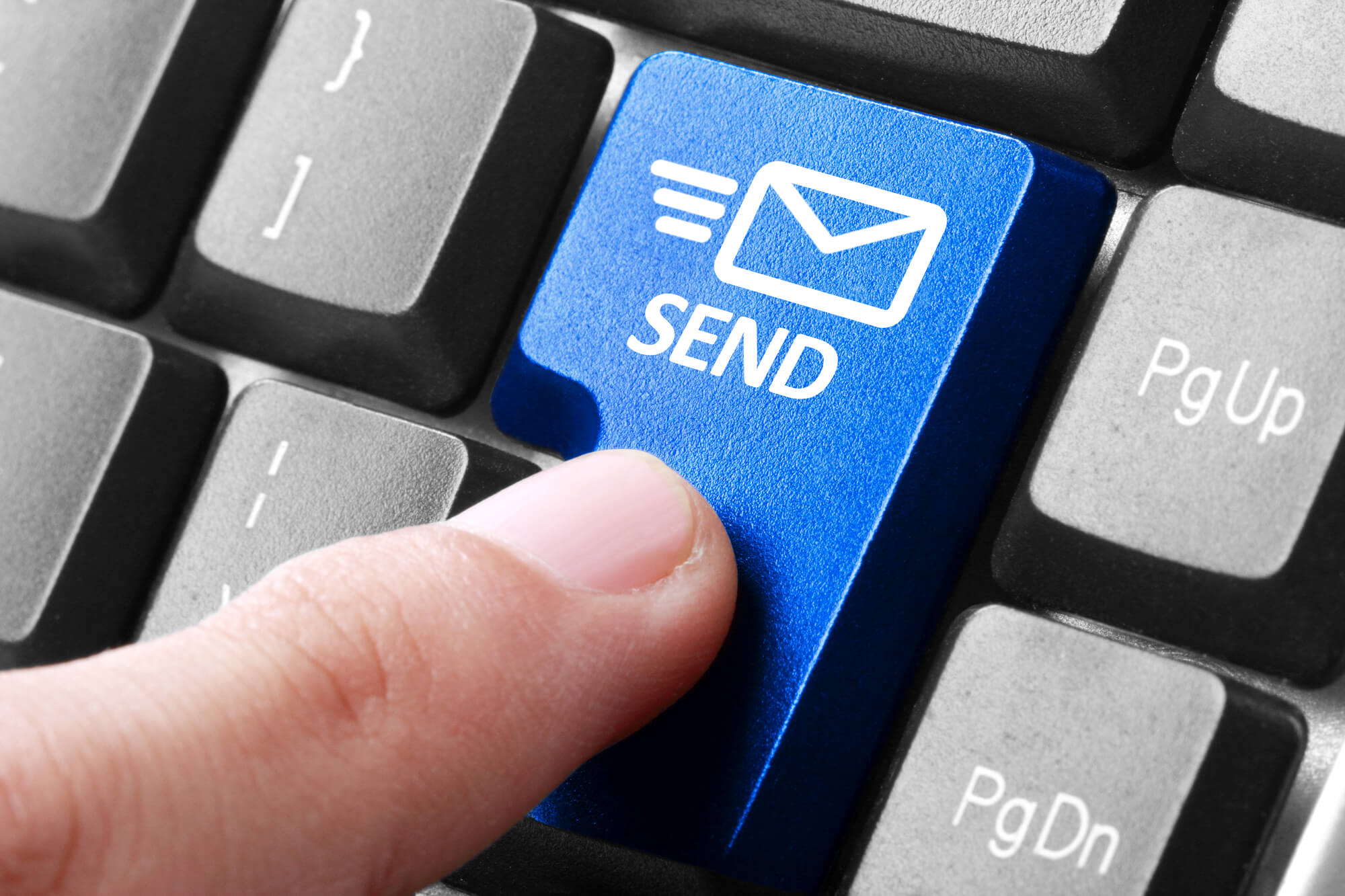 finger pressing send button on keyboard