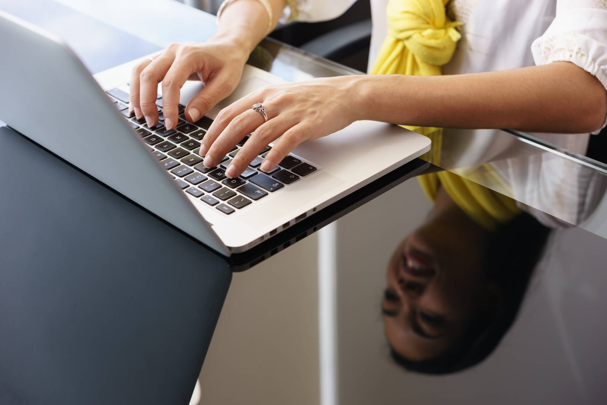 female professional typing on her laptop