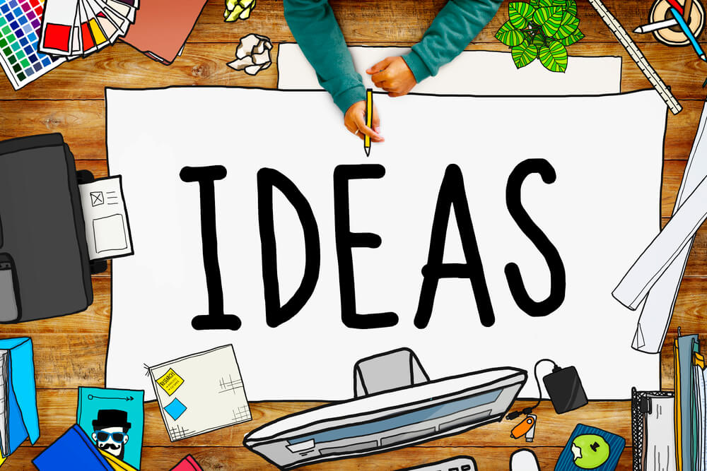 the word idea written on a canvas with art materials around