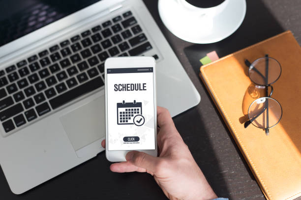 person holding a phone that says schedule