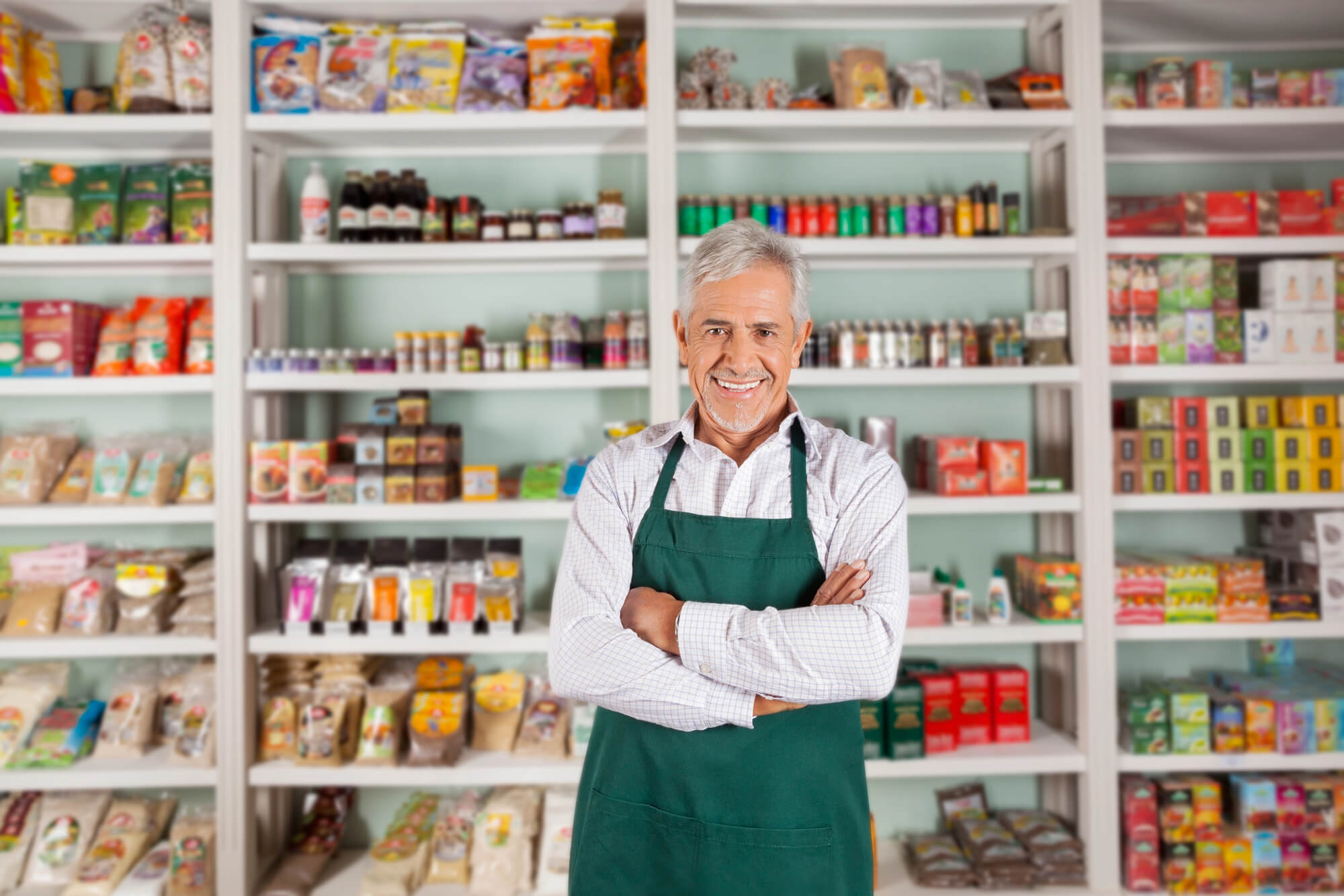 happy franchise owner posing in front of his shop 
