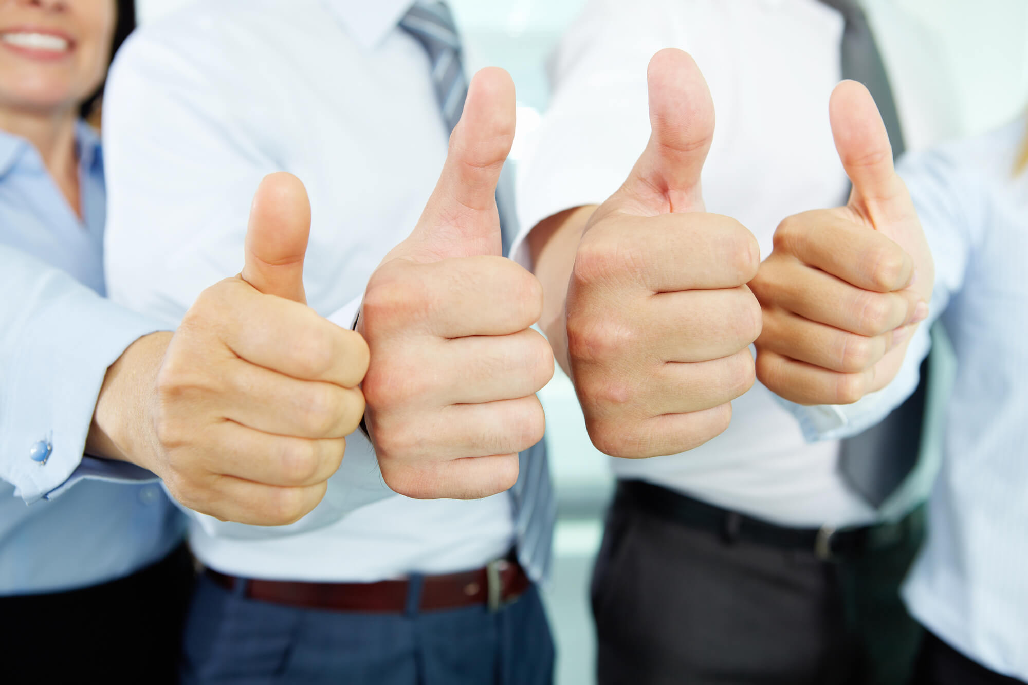 business team holding a thumbs up