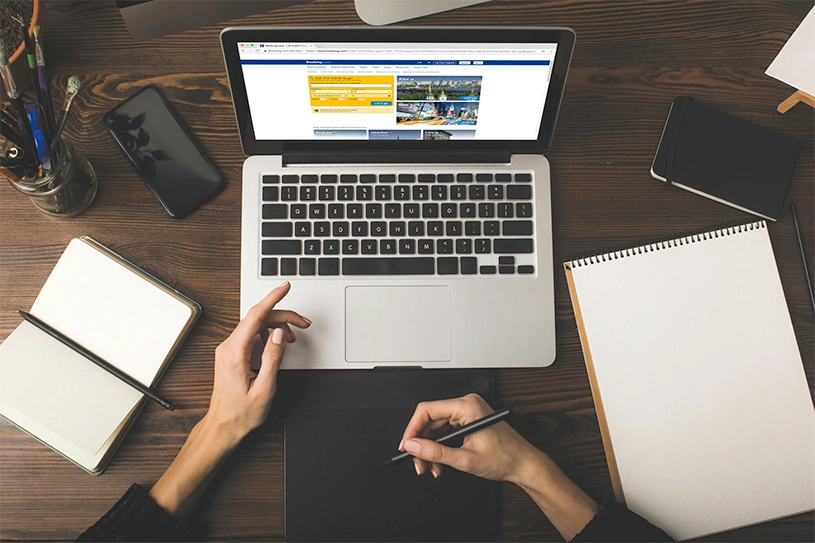 woman sitting on workspace with laptop and notepads nashville web desin