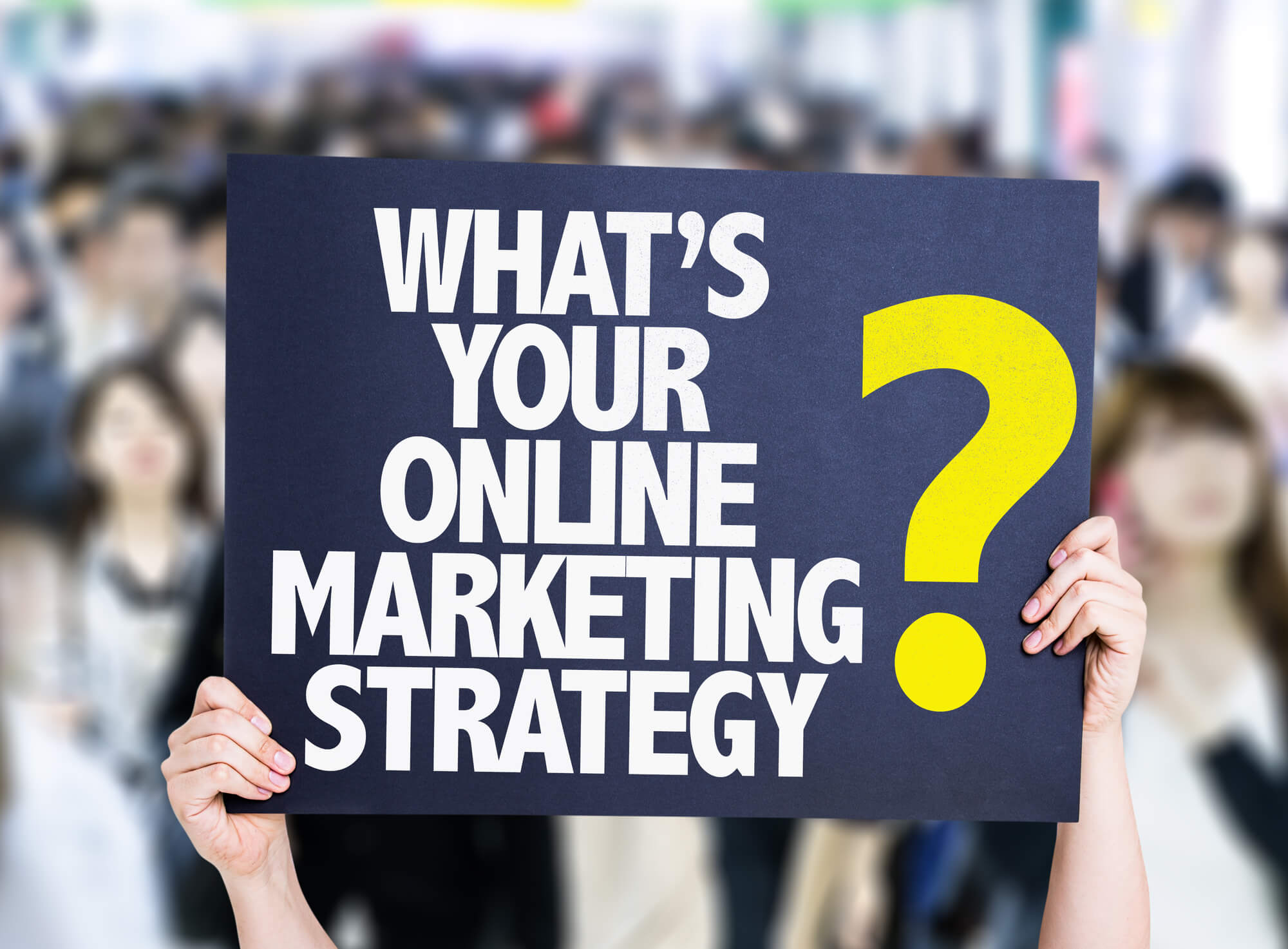 hand holding what's your online marketing strategy sign