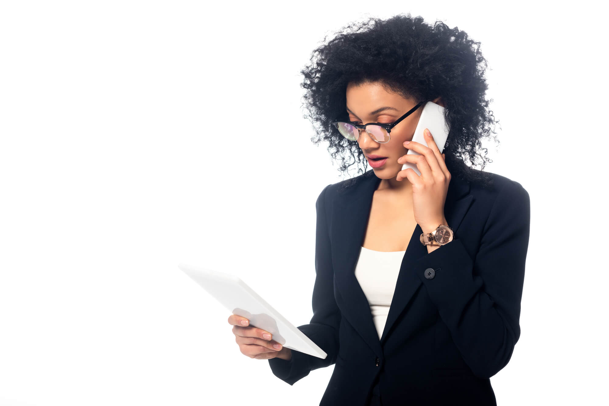 professional woman talking on the phone while looking at tablet