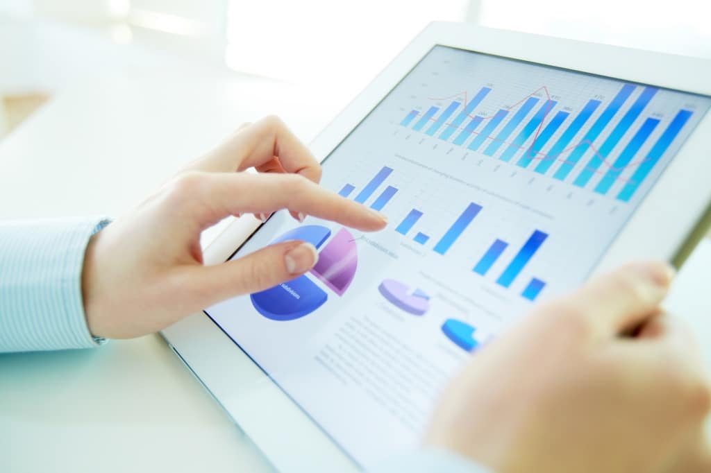 woman assessing graph on mobile tablet digital marketing agency 