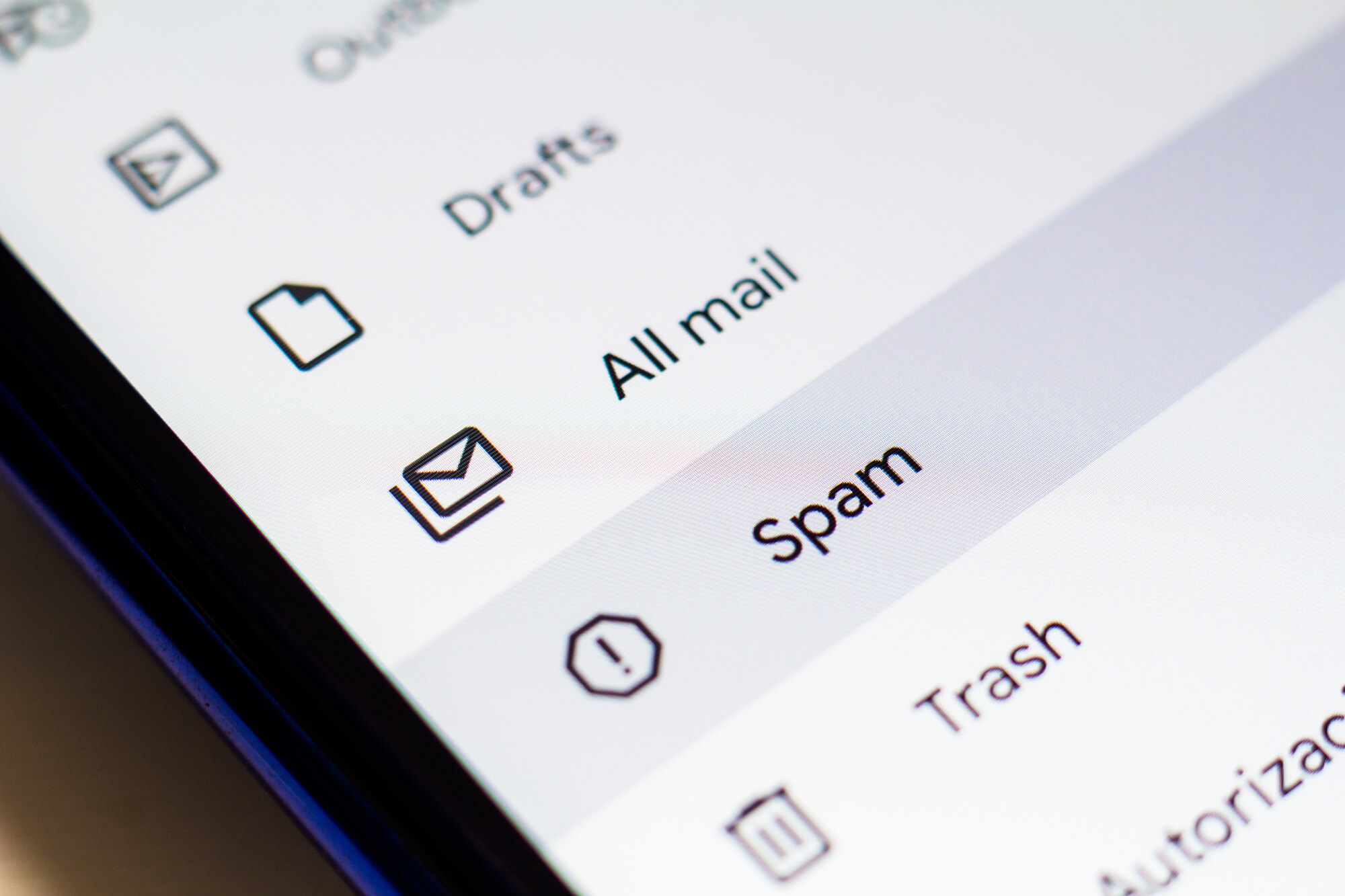 phone showing different email folders and focusing on spam
