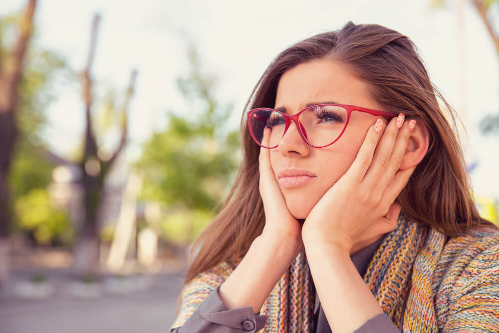 entrepreneur thinking about her self-sabotaging behaviors.