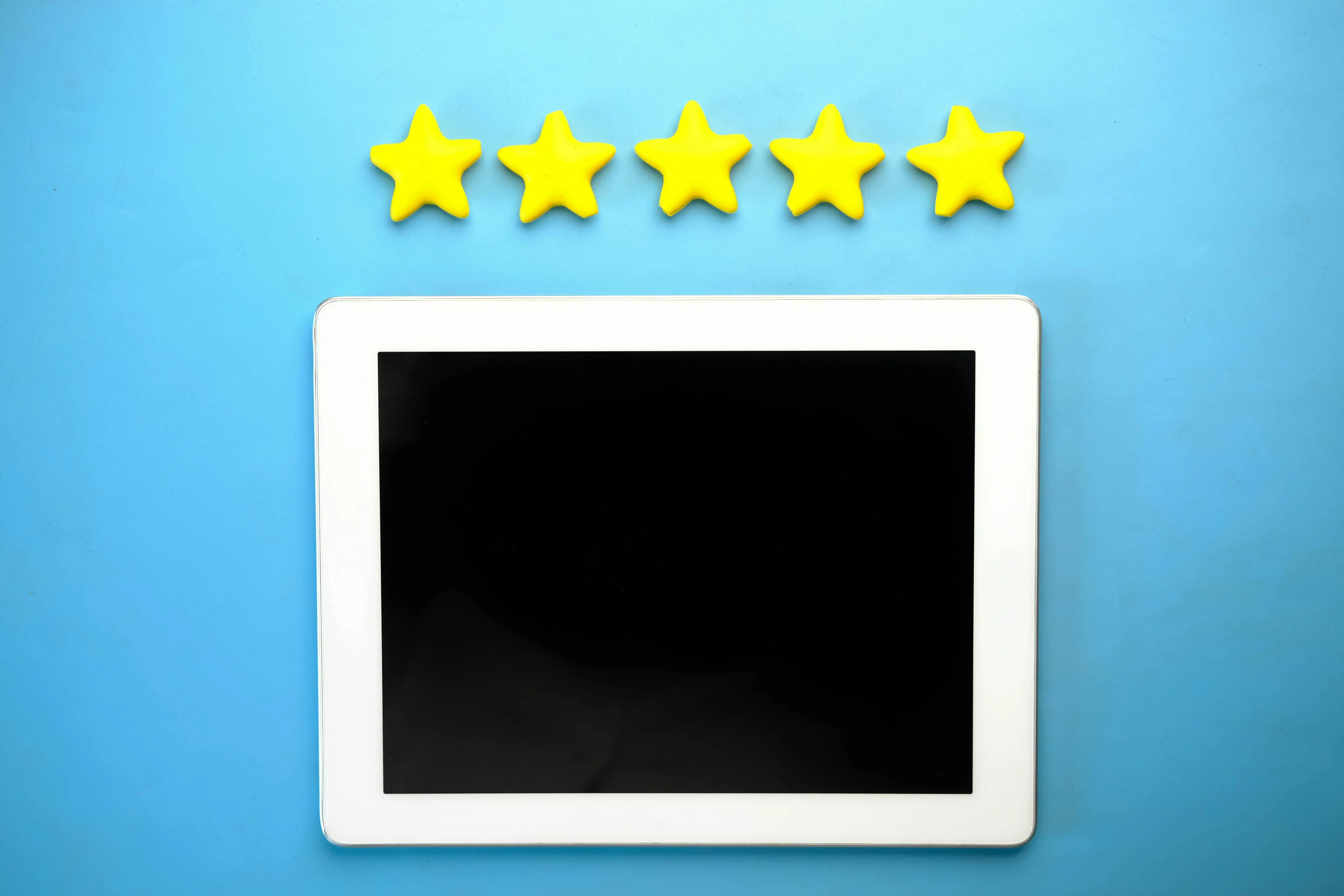 Tablet with 5 yellow stars over it