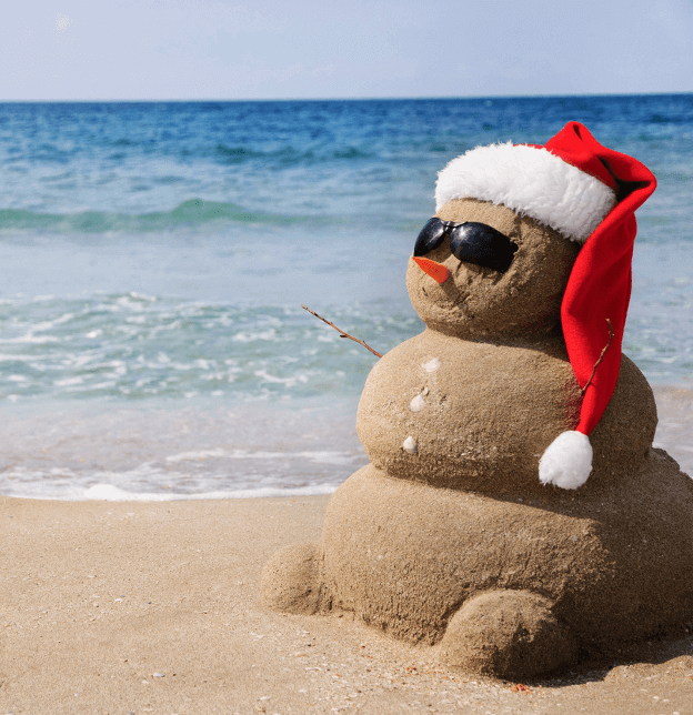 Photo of a snowman at the beach. 