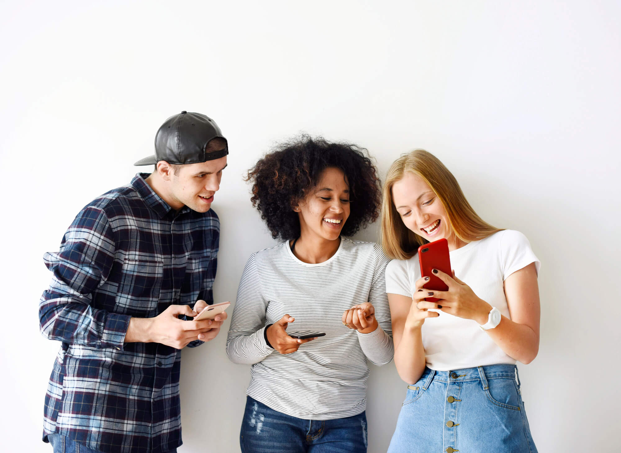 Three friends engage with social media content