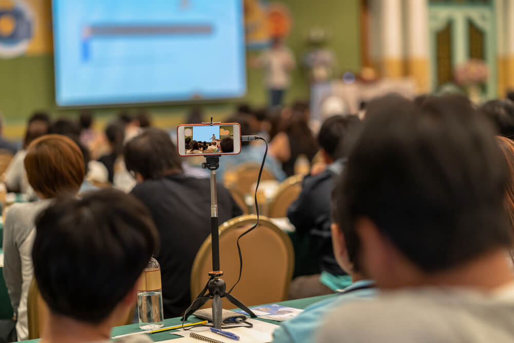picture of employee doing live streaming of seminar