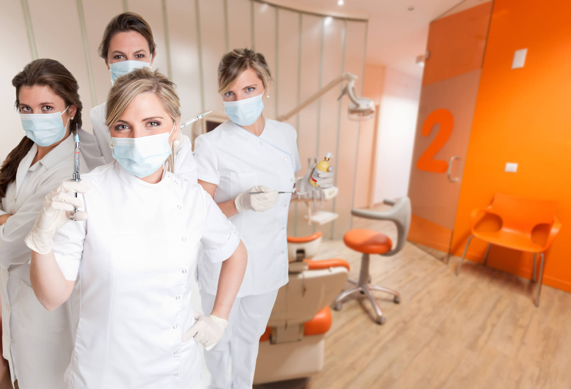 a dentist and her team of dental assistants in a clinic