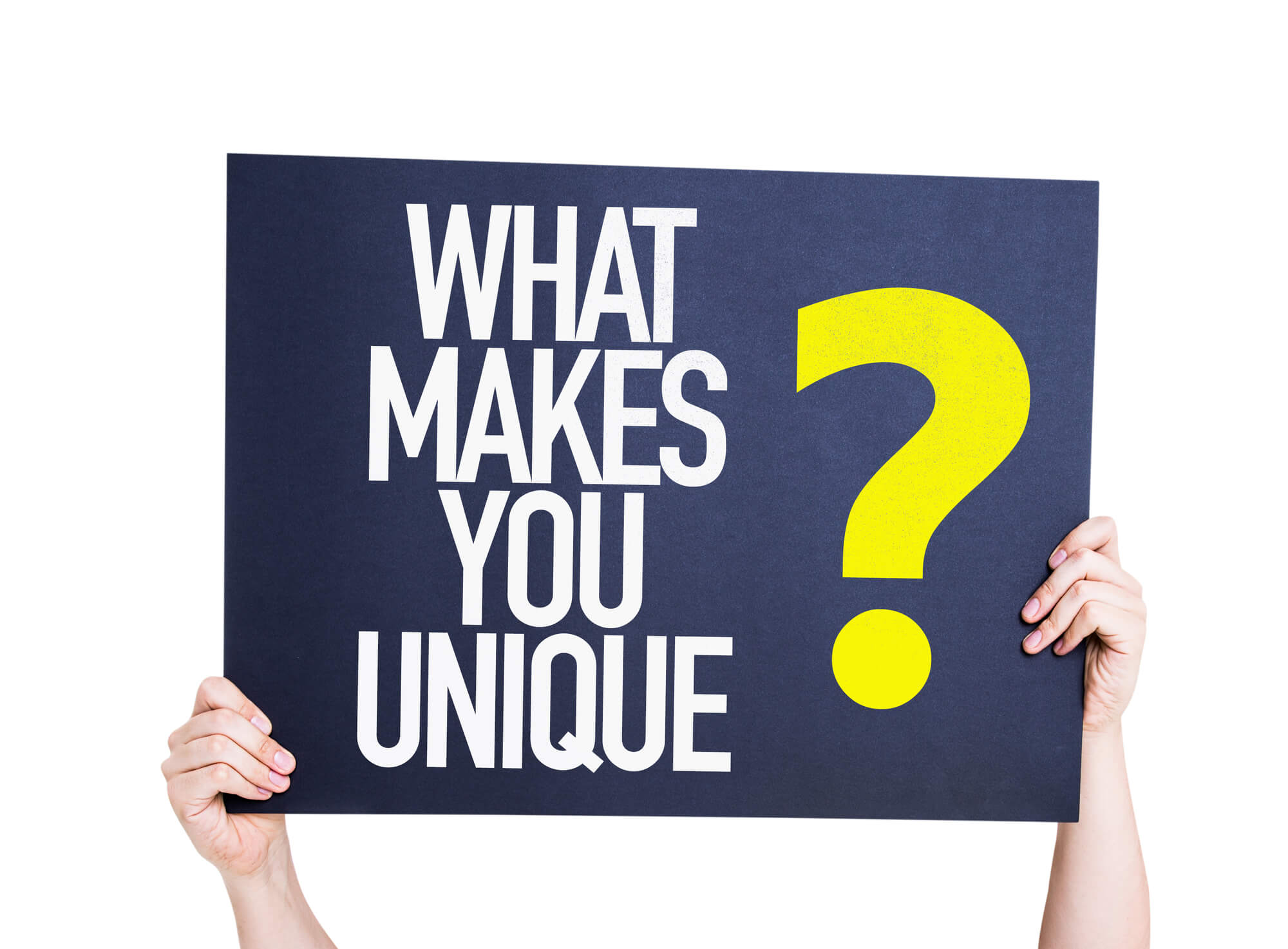 person holding signboard that says what makes you unique