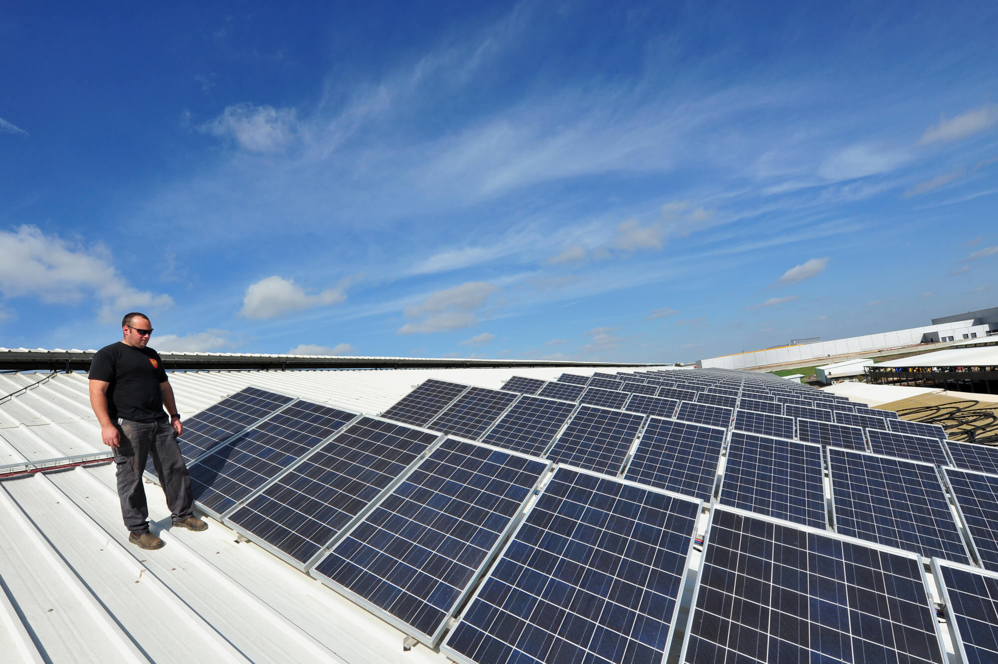 Electrician doing maintenance work on clients' solar panels.