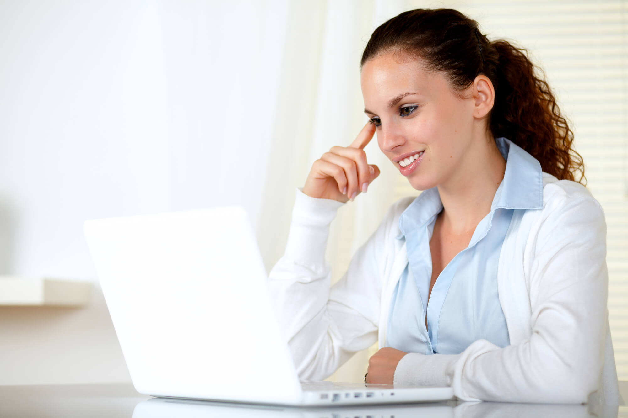 woman reading something intently on her laptop