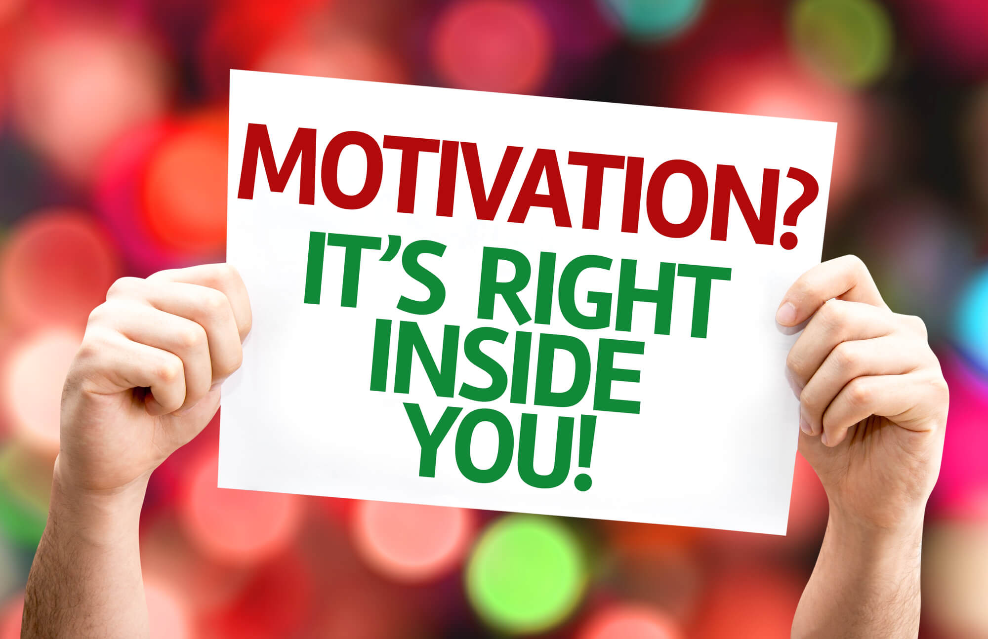 hands holding a signboard saying "motivation? it's right inside you.""